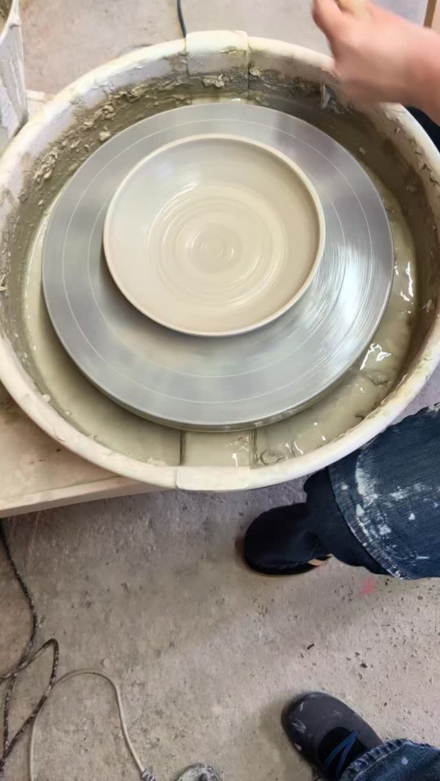 Freshly thrown plate on the pottery wheel