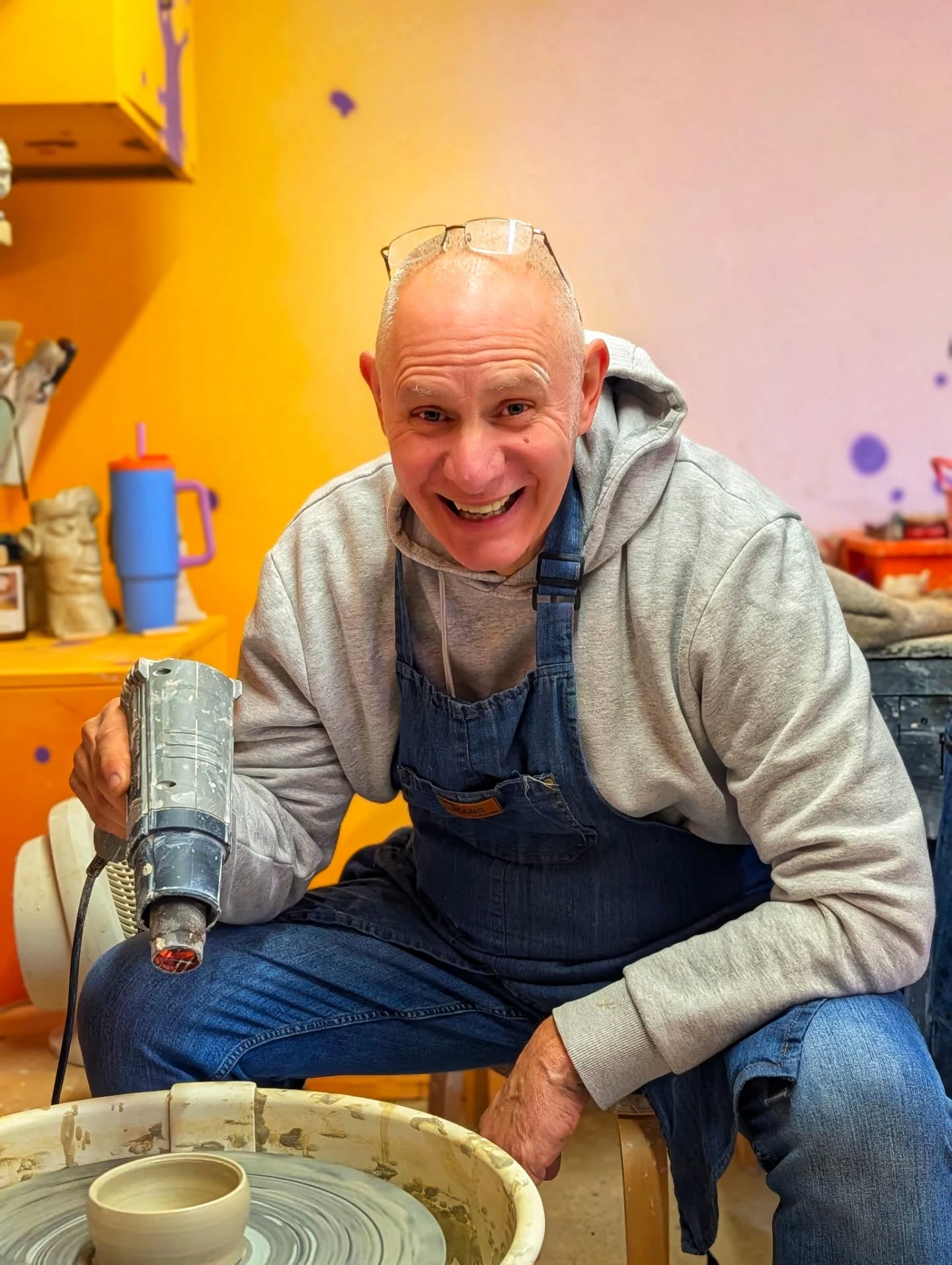 Student grinning at the pottery wheel in the Ceramic Love studio